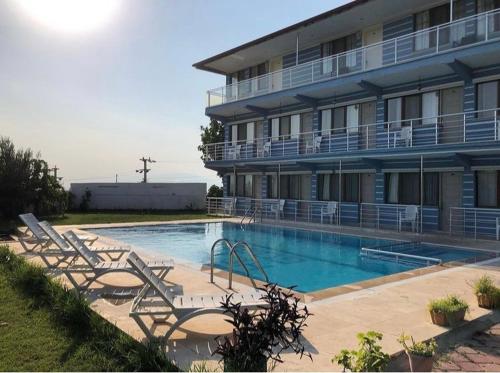 a hotel with a swimming pool in front of a building at Hotel Goreme Sakura in Pamukkale