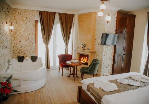 a hotel room with a tub and a bed and a bedroom at Sea House Hotel in Ağva