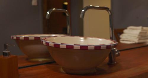a bathroom with a bowl shaped sink and a mirror at LUWİ ANTAKYA BOUTİQUE HOTEL in Hatay