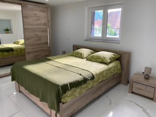 a bedroom with a large bed and a window at L'escapade des randonneurs in Lautenbach