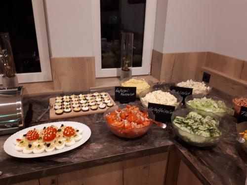 a kitchen counter with appetizers and other food on it at Hotel Bigger Hof - Wirtshaus Platzhirsch am Jahnplatz in Olsberg
