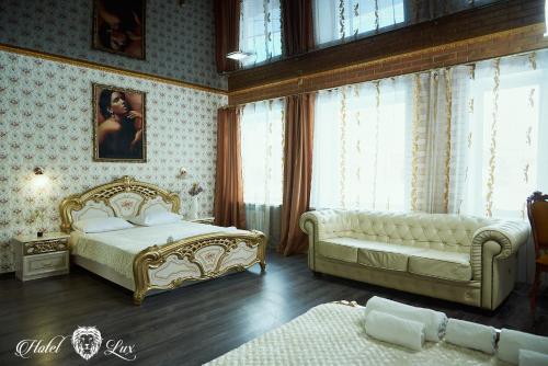 a bedroom with a bed and a couch at Hotel Lux Aquapark in Poltava