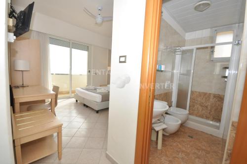 a bathroom with a shower and a toilet in it at Hotel Adriatic&Beauty in Rimini