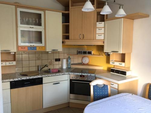 a kitchen with white cabinets and a stove top oven at Poltnigg in Arnfels