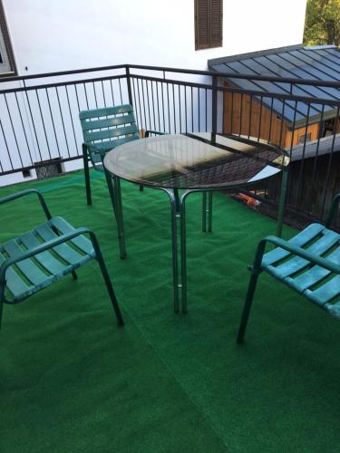 a table and two chairs on a balcony with green grass at Poltnigg in Arnfels