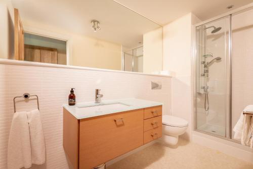 a bathroom with a sink and a shower and a toilet at Adamson Court - 2 Bedroom Flat - Free Parking in St. Andrews