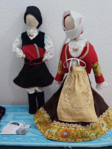 two mannequins in traditional clothing sitting on a table at Sisinedda in Siniscola