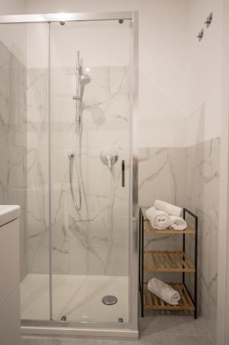 a bathroom with a shower with a glass door at Casanica-Taormina in Taormina