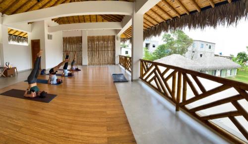 a group of people doing yoga in a building at Vikara in Olón