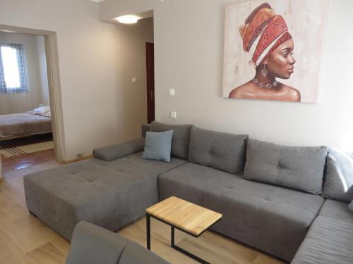 a living room with a couch and a painting on the wall at Apartments Amfa in Biograd na Moru