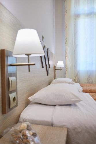Ένα ή περισσότερα κρεβάτια σε δωμάτιο στο Amalia City Rooms