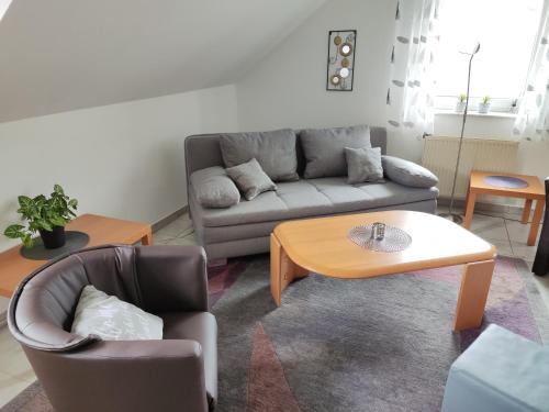 ein Wohnzimmer mit einem Sofa und einem Couchtisch in der Unterkunft Ferienwohnung Kalltalblick in Simmerath