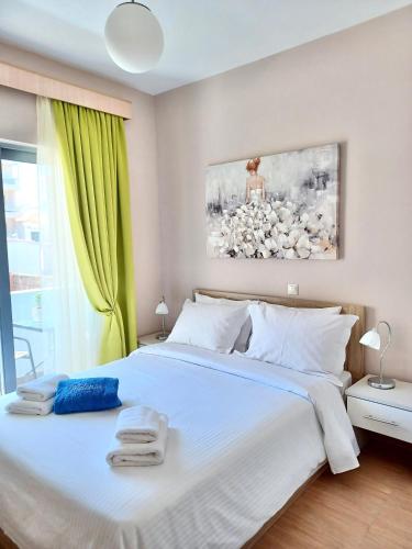 a bedroom with a large bed with towels on it at Melenia Suites in Rhodes Town