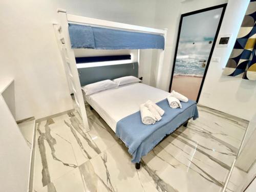 a bedroom with a bed with two towels on it at Al Ristoro in Torre Santa Sabina