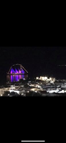 a night view of a stadium with purple lights at Ibiscus Boutique in Mýkonos City
