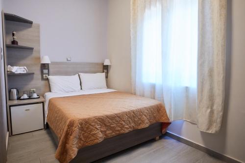 Ένα ή περισσότερα κρεβάτια σε δωμάτιο στο Amalia City Rooms