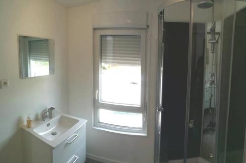 a bathroom with a sink and a shower with a window at Maison à la campagne,à Saint-amand, Pas-de-Calais in Saint-Amand