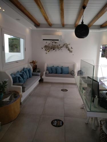 a living room with a couch and a window at Ibiscus Boutique in Mýkonos City