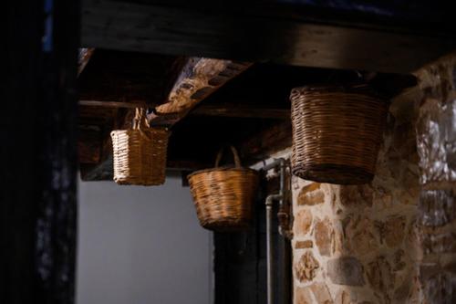 three baskets hanging from the ceiling of a building at Christi Iuxury Apartment in Preveza