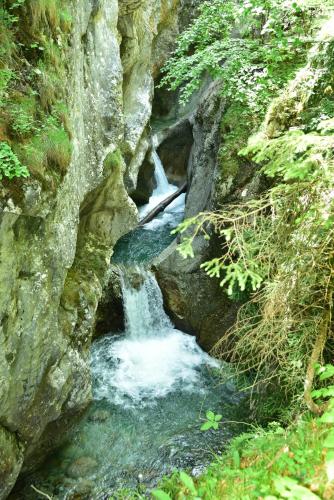 a waterfall in the middle of a rocky river at Apartment Sonnleitn/Nassfeld in Sonnenalpe Nassfeld