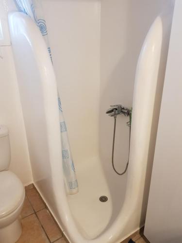 a bathroom with a tub and a toilet at Pigeon House Ornos Beach in Mikonos