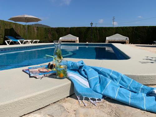 a blue blanket sitting next to a swimming pool at Finca Bona Nit in Jávea