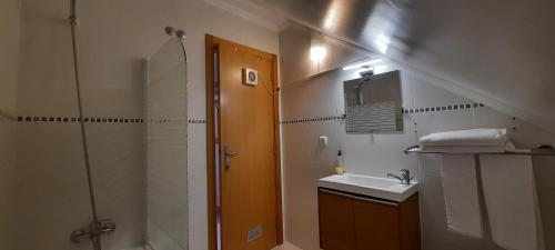 a bathroom with a shower and a sink and a shower at CasAzulApartments in Sintra