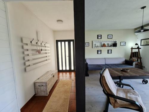 a living room with a wooden table and a couch at Lux Apartment Sunset in Virpazar