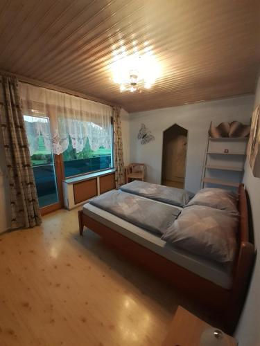 a bedroom with a bed and a window at Appartment Andrea in Eugendorf