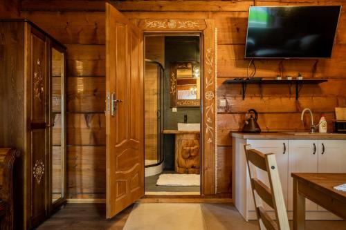 a kitchen with a door leading to a bathroom at Dom Krzesany in Białka Tatrzańska