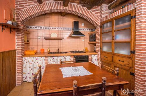 a kitchen with a wooden table in a room at Casa lo Ferre in Beceite