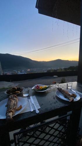 a table with plates of food on it with a view at Садиба Кичера та Кичера Еко in Mizhhirʼʼya