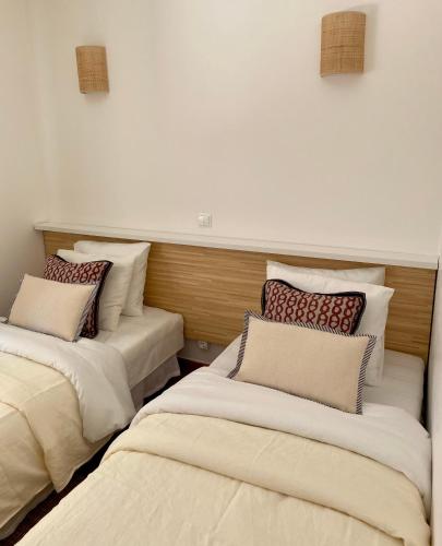 two beds sitting in a room with at Casa da Várzea in Odeceixe