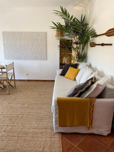 a bedroom with a bed with pillows on it at Casa da Várzea in Odeceixe