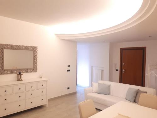 a living room with a white couch and a dresser at Dimora Brezza di Mare in Termoli