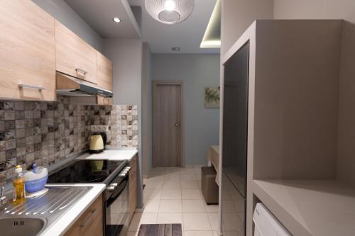 a kitchen with a sink and a stove at Villa Joanna 2 in Thessaloniki