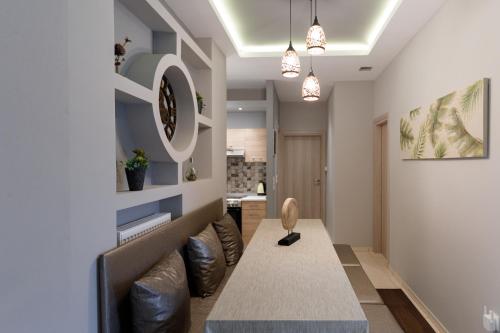 a living room with a bench and a clock on the wall at Villa Joanna 2 in Thessaloniki