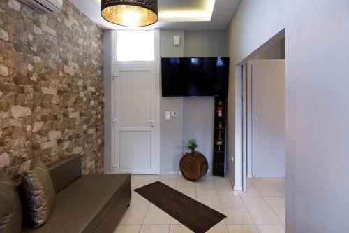 a living room with a couch and a flat screen tv at Villa Joanna 2 in Thessaloniki