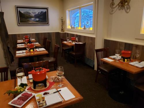 a dining room with wooden tables and chairs at Sun Peaks Lodge in Sun Peaks