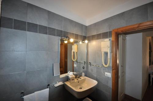 a bathroom with a sink and a mirror at Hotel Villa Casalecchi in Castellina in Chianti