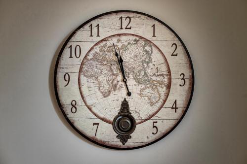 a clock with a map of the world on it at Trapani Home in Trapani