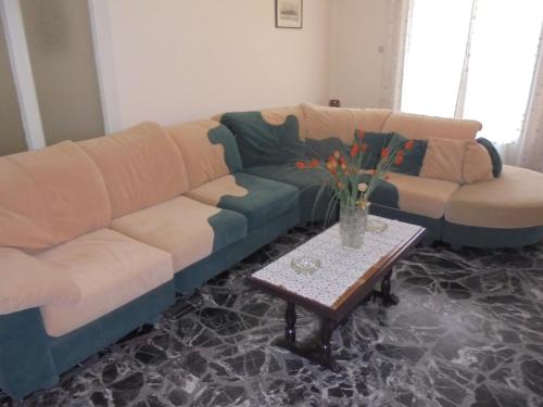 a living room with a couch and a table at Paraskevi's House in Argos