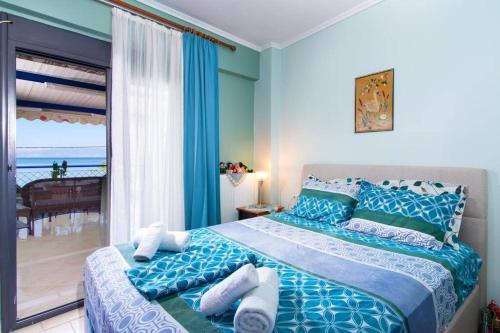 a bedroom with a bed with a view of the ocean at Villa Porto Thassos in Limenas