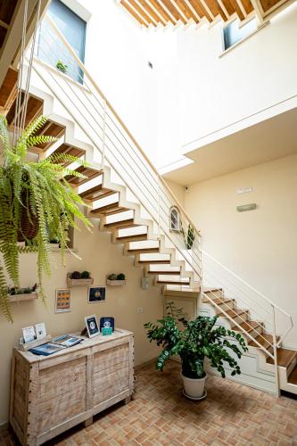 a staircase in a building with a desk and a plant at Trapani Home in Trapani