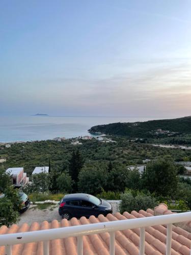 a car parked on a balcony with the ocean in the background at Persephone in Himare