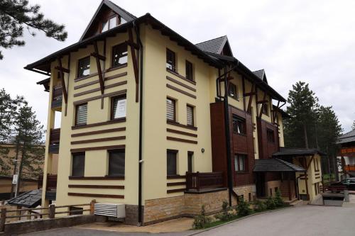 a large house with a gambrel roof at Apartman Svetogorska in Zlatibor