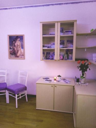 a kitchen with a table and two chairs in a room at Bassano Up in Mussolente 