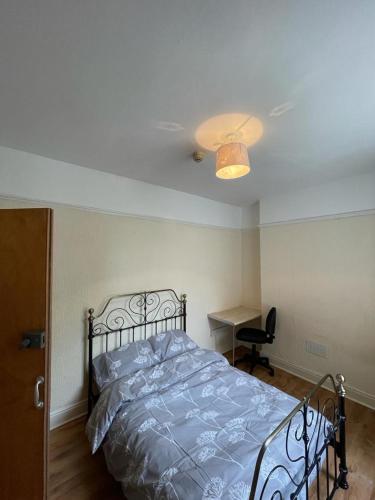 a bedroom with a bed and a desk and a ceiling at 52 Cambrian St in Aberystwyth