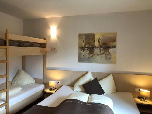 a bedroom with two beds and a bunk bed at Gschlössle Ferienwohnungen in Jerzens
