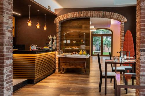 a kitchen with a table and a dining room at Giarvino Boutique Guest House in Acqui Terme